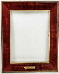 an empty picture frame, with a metal label